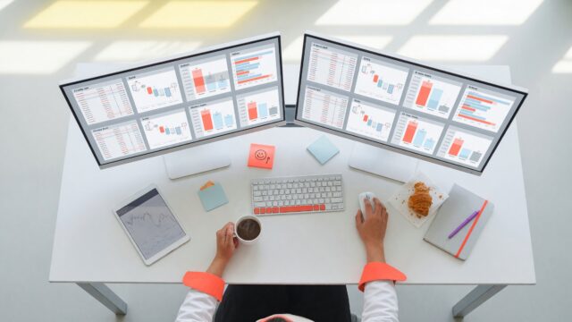 Trader watching perpetual futures order books on two monitors